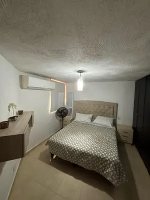 a bedroom with a bed and a desk in it at Comfortable and Relaxing Apartment in Barranquilla