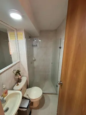a bathroom with a shower and a toilet and a sink at Comfortable and Relaxing Apartment in Barranquilla