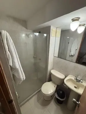 a bathroom with a shower and a toilet and a sink at Comfortable and Relaxing Apartment in Barranquilla