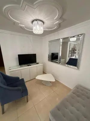 a living room with a couch and a chandelier at Comfortable and Relaxing Apartment in Barranquilla