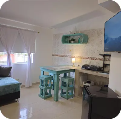 a kitchen with a blue table in a room at Apartamentos Santori in Cartagena de Indias