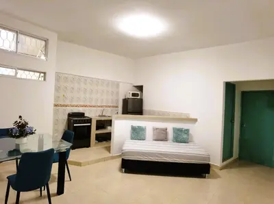 a bedroom with a bed and a table in it at Apartamentos Santori in Cartagena de Indias
