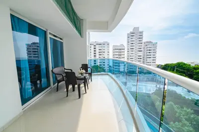 a balcony with chairs and a table on top of a building at Apartamento Unik Cartagena Edificio Poseidón in Cartagena de Indias