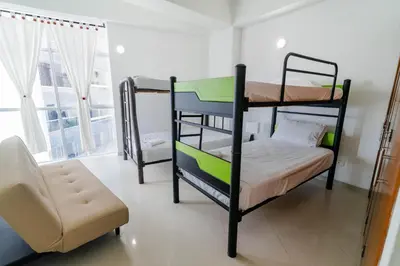 a bedroom with two bunk beds and a chair at Apartamento Unik Cartagena Edificio Poseidón in Cartagena de Indias