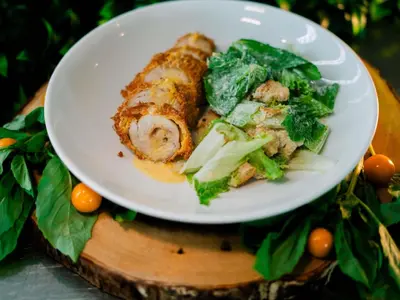 a white plate of food on a wooden table at ibis Cartagena Marbella in Cartagena de Indias