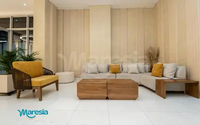 a living room with a couch and a chair at Sunset Oceanfront Studio in Cartagena de Indias