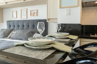 a kitchen with a table with two glasses of wine at Sunset Oceanfront Studio in Cartagena de Indias