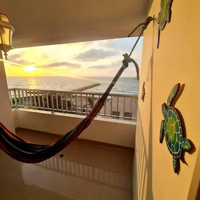 a hammock on a balcony with a view of the ocean at Oceanfront apartment in Cartagena in Cartagena de Indias