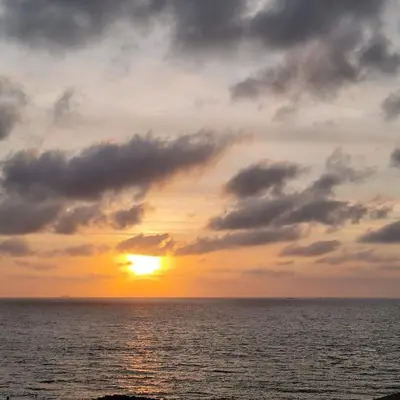 a sunset over the ocean with a cloudy sky at Oceanfront apartment in Cartagena in Cartagena de Indias