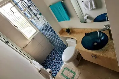 a bathroom with a sink and a toilet and a mirror at Oceanfront apartment in Cartagena in Cartagena de Indias