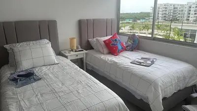 a bedroom with two beds and a window at Cozy apartment Brand new in Cartagena de Indias