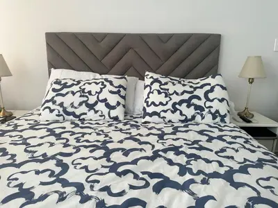 a bed with a blue and white blanket and pillows at Cozy apartment Brand new in Cartagena de Indias