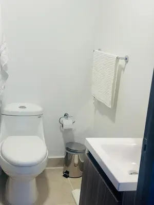 a white bathroom with a toilet and a sink at Cozy apartment Brand new in Cartagena de Indias