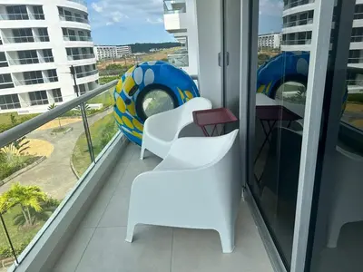 a balcony with two white chairs and a beach ball at Cozy apartment Brand new in Cartagena de Indias