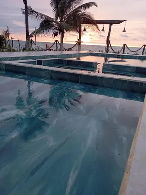 a swimming pool with the ocean in the background at Casa Arrecife San Bernardo del Viento in San Bernardo del Viento