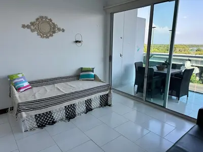 a bedroom with a bed and a table with a view at Morros la boquilla in Cartagena de Indias