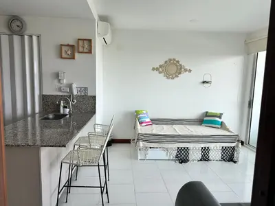 a white kitchen with a bed in a room at Morros la boquilla in Cartagena de Indias