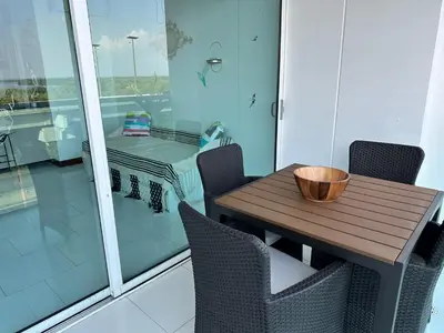 a wooden table and chairs on a balcony at Morros la boquilla in Cartagena de Indias