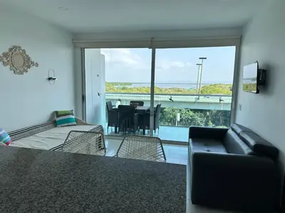 a living room with a couch and a balcony at Morros la boquilla in Cartagena de Indias
