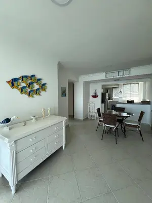 a living room with a table and chairs and a kitchen at Unwind in Santa Martas Oceanfront Retreat in Playa Dormida