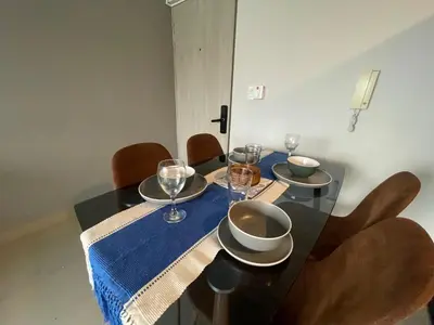 a dining room table with chairs and a blue table cloth at PISO 19 Mirador Oasis Costero in Cartagena de Indias
