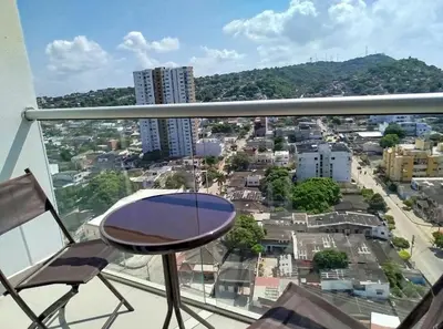 a balcony with a chair and a view of a city at PISO 19 Mirador Oasis Costero in Cartagena de Indias