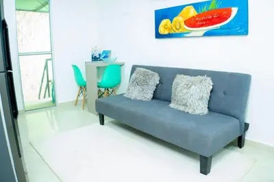 a blue couch sitting in a living room at Boquillas del Mar - Apartamentos in Cartagena de Indias