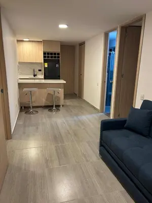 a living room with a couch and a kitchen at Moderno Apartamento en Barranquilla, Miramar in Barranquilla