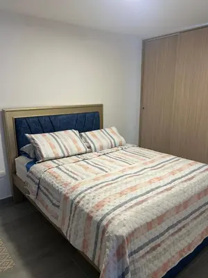 a bedroom with a bed with a striped blanket at Moderno Apartamento en Barranquilla, Miramar in Barranquilla