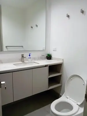 a bathroom with a sink and a toilet and a mirror at Apartamento en la Boquilla Cartagena in Cartagena de Indias