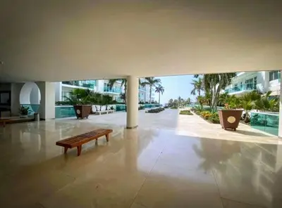 a bench in the middle of a room with a building at Apartamento en la Boquilla Cartagena in Cartagena de Indias
