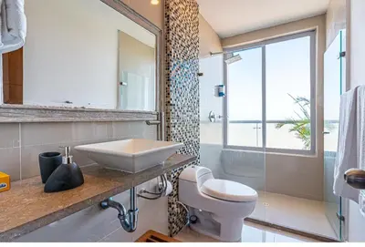 a bathroom with a sink and a toilet and a window at Altamar, disfruta la mejor vista in Cartagena de Indias