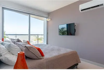 a bedroom with a bed with a tv on the wall at Altamar, disfruta la mejor vista in Cartagena de Indias