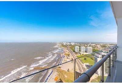 a view of the beach and the ocean from a balcony at Altamar, disfruta la mejor vista in Cartagena de Indias