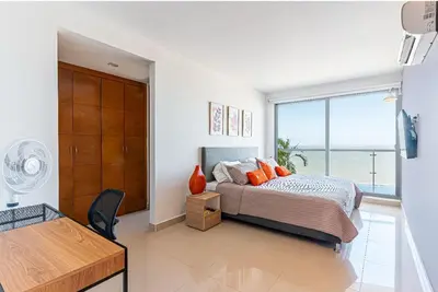 a bedroom with a bed and a large window at Altamar, disfruta la mejor vista in Cartagena de Indias