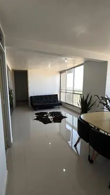 a living room with a couch and a table at Apartamento con Vista espectacular en Barranquilla in Barranquilla