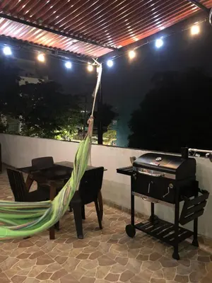 a hammock sitting next to a grill and a piano at Safariplaya in Cartagena de Indias