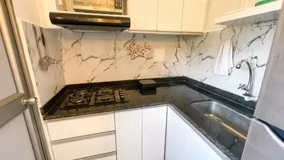 a kitchen with a stove and a sink at Apartamento Coveñas in Coveñas