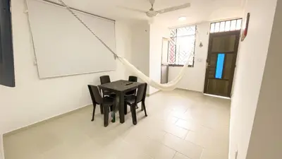 a dining room with a black table and chairs at Apartamento Coveñas in Coveñas