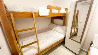 a bunk bed room with two bunk beds and a mirror at Apartamento Coveñas in Coveñas