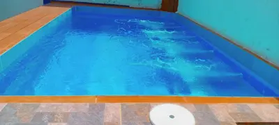 a swimming pool with blue water in a room at Safarihostal in Cartagena de Indias