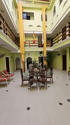 a dining room with a table and chairs in a building at Hotel Barranquilla Inn in Barranquilla