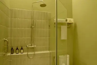 a bathroom with a glass shower with a toilet at Terrazas Hotel Boutique in Cartagena de Indias