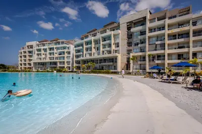 a person swimming in a pool on a beach with buildings at Palmar del Mar in Cartagena de Indias