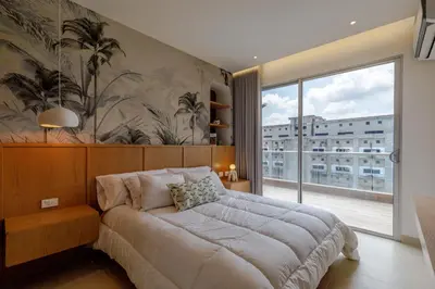 a bedroom with a large bed and a large window at Palmar del Mar in Cartagena de Indias
