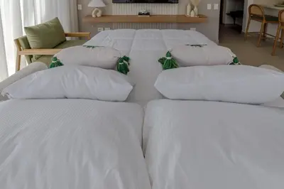 four white pillows on a bed in a room at Palmar del Mar in Cartagena de Indias