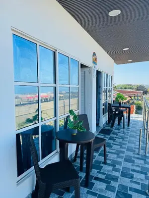 a room with a table and chairs and windows at Apartamentos el mochilero frente al mar piso 2 apto 3 in Cartagena de Indias