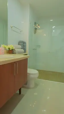 a bathroom with a toilet and a glass shower at Apartamento Vista Mar 1604 in Cartagena de Indias
