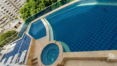 a swimming pool with blue tiles on the side of a building at Apartamento Vista Mar 1604 in Cartagena de Indias