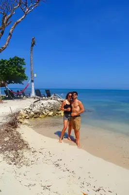 a man and a woman standing on the beach at Tintipán Glamping in Tintipan Island